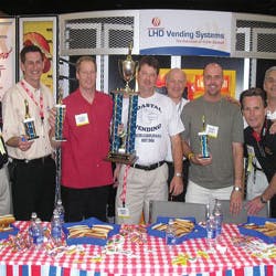 Representatives of ACE joined LHD Vending in honoring the winners of the company&rsquo;s hot dog eating contest, which took place on the show floor. At left are: Alan Plaisted, Southern Refreshment Services, Tucker, Ga., ACE representative; Darrell Sims, Southern Refreshment Services, representing Georgia, 4th place; John Fourqurean, Gallins Vending Service, Winston/Salem, N.C., representing North Carolina, 2nd place; Jason Mims, Coastal Vending &amp; Food Service, Charleston, S.C., representing South Carolina, 1st place; Leon Leykin, LHD Vending; Geoff Cook, RE Services Inc., Chesapeake, Va., representing Virginia, 3rd place; John Trego, Coastal Vending &amp; Food Service, ACE representative; and Greg Westnedge, LHD Vending.