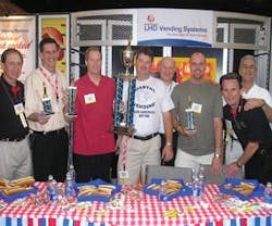 Representatives of ACE joined LHD Vending in honoring the winners of the company’s hot dog eating contest, which took place on the show floor. At left are: Alan Plaisted, Southern Refreshment Services, Tucker, Ga., ACE representative; Darrell Sims, Southern Refreshment Services, representing Georgia, 4th place; John Fourqurean, Gallins Vending Service, Winston/Salem, N.C., representing North Carolina, 2nd place; Jason Mims, Coastal Vending & Food Service, Charleston, S.C., representing South Carolina, 1st place; Leon Leykin, LHD Vending; Geoff Cook, RE Services Inc., Chesapeake, Va., representing Virginia, 3rd place; John Trego, Coastal Vending & Food Service, ACE representative; and Greg Westnedge, LHD Vending. Representatives of ACE joined LHD Vending in honoring the winners of the company’s hot dog eating contest, which took place on the show floor. At left are: Alan Plaisted, Southern Refreshment Services, Tucker, Ga., ACE representative; Darrell Sims, Southern Refreshment Services, representing Georgia, 4th place; John Fourqurean, Gallins Vending Service, Winston/Salem, N.C., representing North Carolina, 2nd place; Jason Mims, Coastal Vending & Food Service, Charleston, S.C., representing South Carolina, 1st place; Leon Leykin, LHD Vending; Geoff Cook, RE Services Inc., Chesapeake, Va., representing Virginia, 3rd place; John Trego, Coastal Vending & Food Service, ACE representative; and Greg Westnedge, LHD Vending.