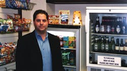Aaron Speagle of Piedmont Vending Inc. checks on a Freedom Shopping kiosk.