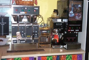 A downtown coffee shop serviced by Karsay Coffee has a grinder, a batch brewer, an espresso machine, an automatic drip brewer and a powdered cappuccino dispenser.