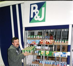 Driver Jay Hathaway loads a truck at P & J's Vending. The telemetry allows the company to know specifically what the location needs.