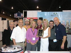 Shamrock Farms Inc. presents its 2006 broker of the year award to Pacific Brokerage. First row at left are Bob Mattias (white shirt), Theresa Gee-Horn (purple shirt), Lisa Dezember (white dress). Second row at left are John Neidivier, Stu Case (orange shirt), Tom Scherrer (maroon shirt), Brad Leech (glasses and gray shirt) and Randy Collins (dark blue shirt). In the third row, last but not least, are Susie Ratner and Wendy Kildebeck.