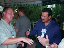 John Eastlack, Canteen Vending Service, St. Petersburg, Fla., left, greets Alberto Velez of Crane Merchandising Systems. John Eastlack, Canteen Vending Service, St. Petersburg, Fla., left, greets Alberto Velez of Crane Merchandising Systems.