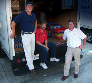 Paul Housman, seated, appreciates the support he gets from Greg Whitehead, left, and Jason Banwart
