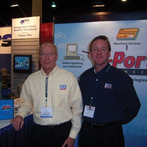 Tom McCarty, left, and Mike Lawlor of USA Technologies Inc. educate kiosk operators about the e-Port at the KioskCom Self Service Expo at the Mandalay Bay Convention Center in Las Vegas, Nev.