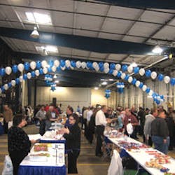 Attendees visit exhibitor booths at Concession Services Inc.&rsquo;s open house in Alsip, Ill.