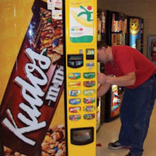 Ron Robinson of Cardinal Vending in Columbus, Ohio services a machine featuring the Snackwise program.