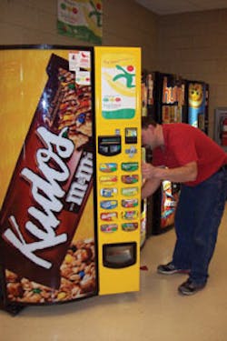 Ron Robinson of Cardinal Vending in Columbus, Ohio services a machine featuring the Snackwise program. Ron Robinson of Cardinal Vending in Columbus, Ohio services a machine featuring the Snackwise program.