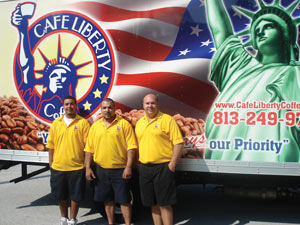 Angel Roman, left, and his father, Luis Figueroa, are also from New York. They join Frank in front of a delivery truck bearing a patriotic logo. Many of the company&rsquo;s customers moved to Florida from the New York metro area.