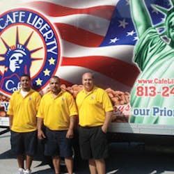 Angel Roman, left, and his father, Luis Figueroa, are also from New York. They join Frank in front of a delivery truck bearing a patriotic logo. Many of the company&rsquo;s customers moved to Florida from the New York metro area.