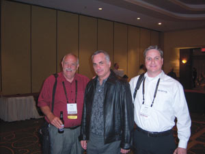 Steve Hyde, left, and Jason Collage, right, greet Scott Guardino of Paramount Automated Food Service, Pompano Beach, Fla.
