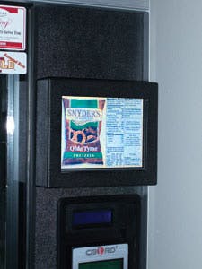 A video screen on a vending machine displays nutrition information for a product with high nutritional value.