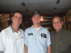 Bill Blauvelt, left, general manager, and Jerry Jacobs, right, congratulate Scott Ralston of Snack Time Vending, Inc.
