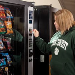 A student uses the student ID card at a snack machine.
