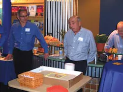 Brent Garson, left, introduces his father, Lester Garson, during the cake cutting at the 50th anniversary Vendors Exchange International open house. Brent Garson, left, introduces his father, Lester Garson, during the cake cutting at the 50th anniversary Vendors Exchange International open house.