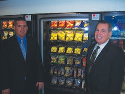 Jamie Campbell, left, and Ed Campbell check on a snack machine where they have quadrupled its top selling facings.
