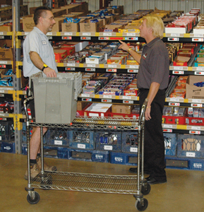 Bryon Buege, D&R Canteen&rsquo;s warehouse manager, left, learns about the Innovative Picking Technologies&rsquo; pick-to-light system from Stu Riemann, project manager. The system integrated seamlessly with MEI&rsquo;s Easitrax software and eliminated the need for drivers to spend time picking products in the warehouse.