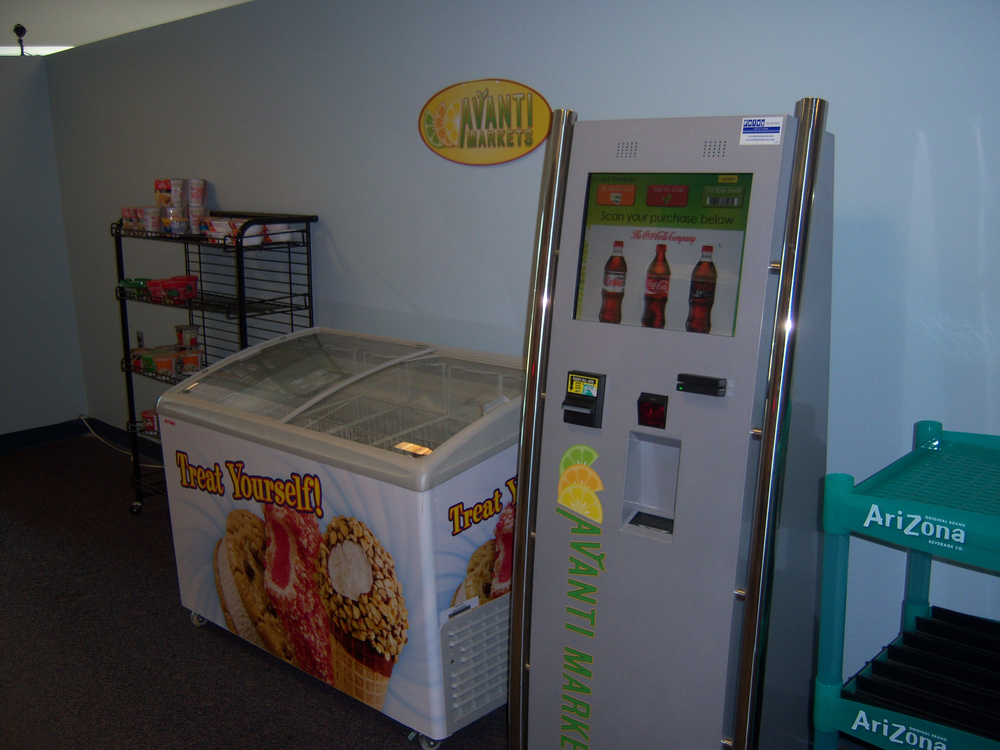 The self checkout kiosk has a touchscreen that runs programmed advertising.