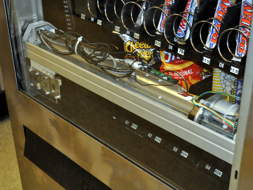 A digital camera rides on a track in the machine and takes pictures of individual products.