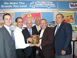 Michael Franceschino, second from the left, and Jim Finelli, fifth from the left, of The Promotion In Motion Companies, Inc. present the award for exceptional sales growth in 2010 on the East Coast to Michael Kelley, left, Lou Pace, Sr.; Jim Saunders and Bob Myers, Jr. of Quality Brokerage Inc. in Turnersville, N.J.