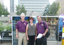 Laura Kelly of P&amp;J&apos;s Vending in Hopkington, Mass. joins Dan Mathews of the National Automatic Merchandising Association, left, and John Healy of Healy &amp; Schulte at the first Gratitude Tour in Boston, Mass.