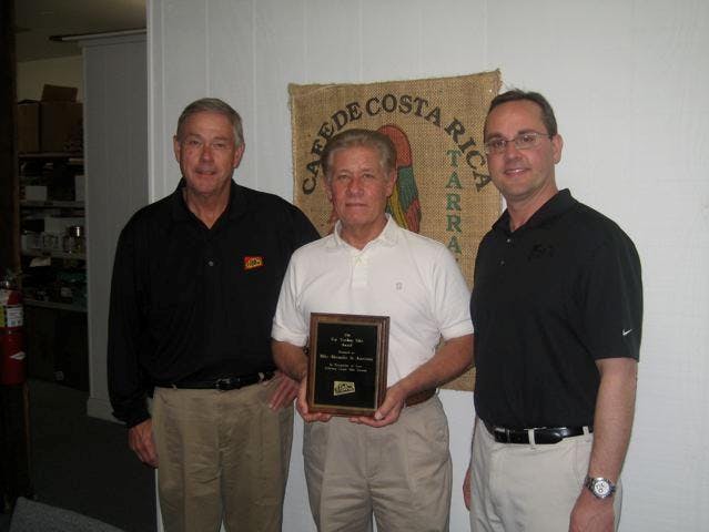 Mike Alexander of J. Michael Alexander, center, accepts the Deli Express 2011 broker award from Dale Dearstyne, left, and Joe Goman.
