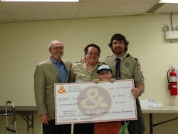 John Leipold, left, of Goetze presents the check to scout leaders Debbie and James Sanders and winning scout James Sanders, Jr. John Leipold, left, of Goetze presents the check to scout leaders Debbie and James Sanders and winning scout James Sanders, Jr.
