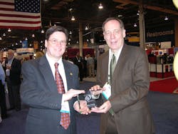 Mike Craig, left, South regional manager at Palm Harbor, Fla.-based G&amp; J Marketing and Sales, receives the 2011 Automatic Merchandiser Readers Choice Broker of the Year Award from Elliot Maras, editor of Automatic Merchandiser Magazine.