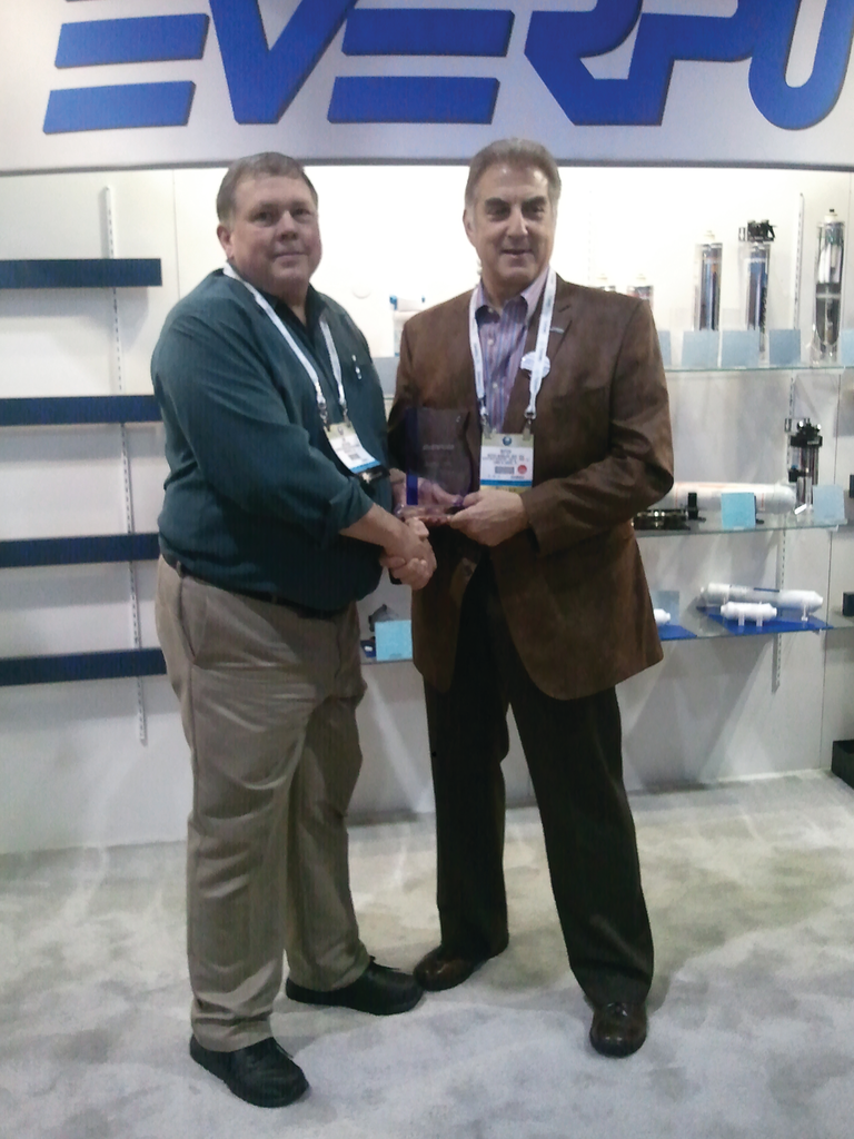 Jim Nelson of Everpure, left, welcomes Butch Winkler of Holiday House Distributing, Land O'Lakes, Fla., to the Everpure Coffee and Office Water 3 Million Dollar Club.