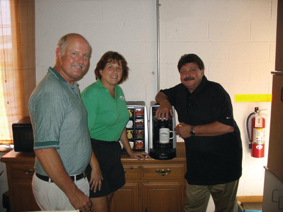 Tom and Renee Ridenour of Pine Mountain Springs, left, talk with Kraft technician Larry Tiernan about the Tassimo brewer, a popular option for high end office coffee clients that want specialty coffee drinks.