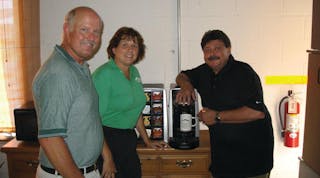 Tom and Renee Ridenour of Pine Mountain Springs, left, talk with Kraft technician Larry Tiernan about the Tassimo brewer, a popular option for high end office coffee clients that want specialty coffee drinks.