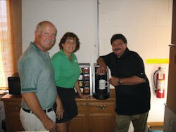 Tom and Renee Ridenour of Pine Mountain Springs, left, talk with Kraft technician Larry Tiernan about the Tassimo brewer, a popular option for high end office coffee clients that want specialty coffee drinks.
