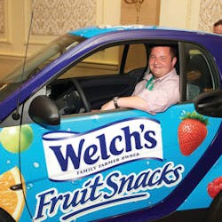 Tim VanGels takes a seat in the Promotion In Motion Smart Car he just won during the Vistar annual meeting at the Chicago Hilton.