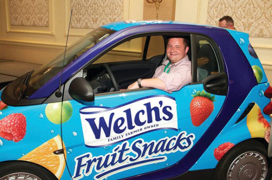 Tim VanGels takes a seat in the Promotion In Motion Smart Car he just won during the Vistar annual meeting at the Chicago Hilton.