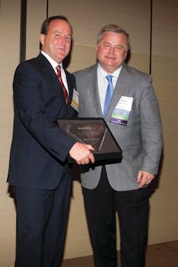 Marty Wilson, Sugar Foods Corp., left ,receives UniPro Marty Whelan Entrepreneur and Leadership Award from Roger Toomey of UniPro Foodservice.