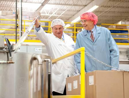 President of Promotion In Motion, Michael Rosenberg, gives U.S. Representative Rush Holt a peek into the cooking processes around the Promotion In Motion facility in Somerset, NJ.