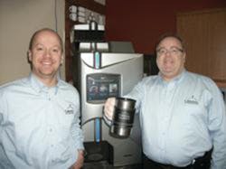 Cafection executives Frank Baron, left, and Denis Maill&eacute; proudly celebrate a record sales month.
