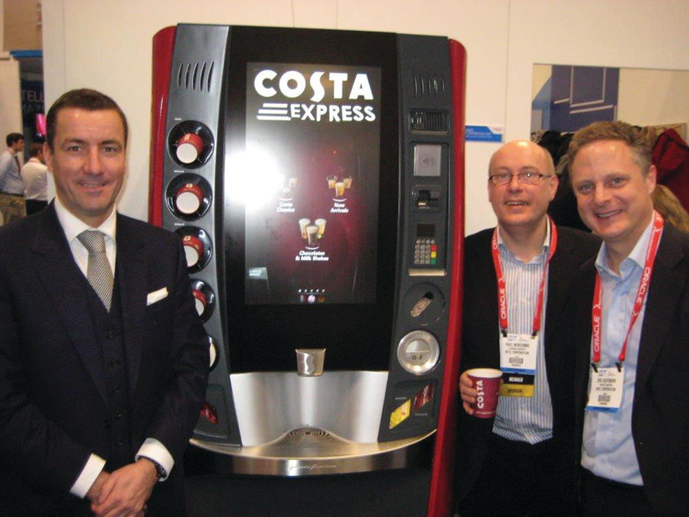 Jim Slater of Costa, left, Paul Newcombe of Intel Corp. and Eric Achtmann of Costa exhibit the multi-sensory experience single-serve hot beverage machine at the National Retail Federation show in January.