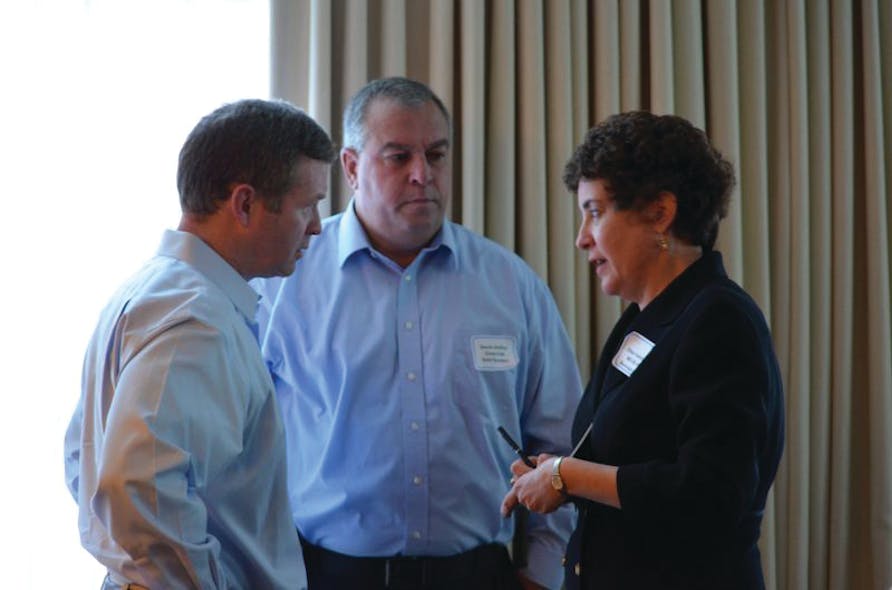 Tom McCarthy (left) and David Jenkins (right) of Coca-Cola Co. speak with Ellen Valentino of the MD-DE-DC Beverage at the 2013 MD-DC Annual Meeting.