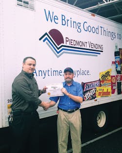 Piedmont Vending Operations Manager Jeff Anna presents Mike Hill with a Certificate of Nomination. Piedmont Vending Operations Manager Jeff Anna presents Mike Hill with a Certificate of Nomination.