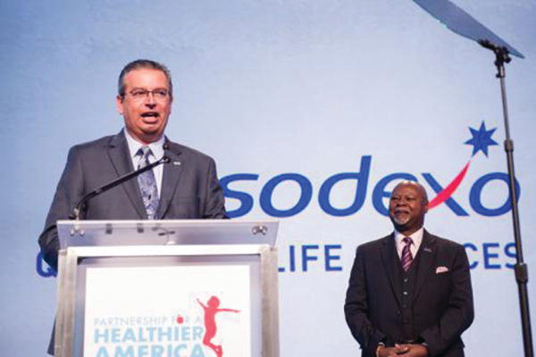 Sodexo President and CEO George Chavel joins Partnership for a Healthier America Board Chair James R. Gavin III, MD, PhD to announce the company's new commitments aimed at fighting childhood obesity at the 2014 Building a Healthier Future Summit in Washington. (PRNewsFoto/Sodexo)