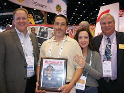 Dave Wilcox (far left) and Paul Schindelar (far right) of Mondelez International present Mike Edwards accompanied by his wife, Jennifer, with the 2013 Route Driver of the Year award. Edwards of Greensboro Vending located in Greensboro, N.C., was selected out of over 100 nominations to win the award. Read more about Edwards at www.vendingmarketwatch.com/11317885. Dave Wilcox (far left) and Paul Schindelar (far right) of Mondelez International present Mike Edwards accompanied by his wife, Jennifer, with the 2013 Route Driver of the Year award. Edwards of Greensboro Vending located in Greensboro, N.C., was selected out of over 100 nominations to win the award. Read more about Edwards at www.vendingmarketwatch.com/11317885.