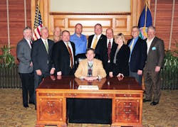 Kansas Governor Sam Brownback (center), surrounded by Mike Cox, John Barnes, Denny Burgess, Chip Stephenson, Joe Hemmelgarn, Claude Bockhold, Bill Bradford, Sandy Larson, Keith Bottorff and Tom Burgess. Kansas Governor Sam Brownback (center), surrounded by Mike Cox, John Barnes, Denny Burgess, Chip Stephenson, Joe Hemmelgarn, Claude Bockhold, Bill Bradford, Sandy Larson, Keith Bottorff and Tom Burgess.