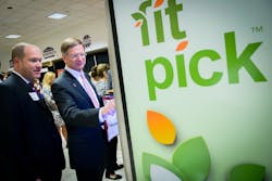 Eric Dell (left), SVP of Government Affairs at NAMA, shows off a FitPick machine. Military health officials want to make better-for-you food options more accessible on military bases and part of that push would place products in vending machines that align with NAMA’s FitPick and FitPick Select standards. Eric Dell (left), SVP of Government Affairs at NAMA, shows off a FitPick machine. Military health officials want to make better-for-you food options more accessible on military bases and part of that push would place products in vending machines that align with NAMA’s FitPick and FitPick Select standards.