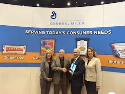 Tom Ganley of BBI Pacific accepts the General Mills 2016 West Region Broker of the Year honor at the recent NAMA OneShow. Pictured from left to right are; Lisa Mattias (BBI), Mark Kelley (General Mills West Region Sales Manager), Tom Ganley (BBI Pacific Region Manager), and Wendy King (BBI). Tom Ganley of BBI Pacific accepts the General Mills 2016 West Region Broker of the Year honor at the recent NAMA OneShow. Pictured from left to right are; Lisa Mattias (BBI), Mark Kelley (General Mills West Region Sales Manager), Tom Ganley (BBI Pacific Region Manager), and Wendy King (BBI).