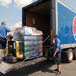 PBC employees load a Pepsi delivery truck