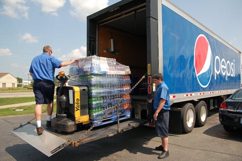 PBC employees load a Pepsi delivery truck