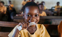 Mary Afrakomah, 7, at the Hemang Buoho D/A Primary School, Afigya Kwabre District, Ashanti Region, Ghana, holding a Vivi packet, a vitamin fortified groundnut-based snack that is provided to 50,000 school children in Ghana every day through Hershey’s Energize Learning program. Mary Afrakomah, 7, at the Hemang Buoho D/A Primary School, Afigya Kwabre District, Ashanti Region, Ghana, holding a Vivi packet, a vitamin fortified groundnut-based snack that is provided to 50,000 school children in Ghana every day through Hershey’s Energize Learning program.