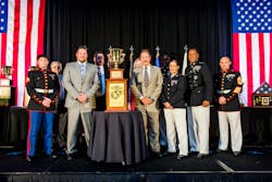 Back Row, Left to Right: Jay Stieber, Gary Walls, Sam Facchini, Dawn Sweeney, Capt. Derrick Oliver. Front Row, Left to Right: Cpl. Brady Wocher, Andrew Bessemer, Barry Lee, W.O. Maria Marques, Major General Craig Crenshaw, and MGySgt Brian Blanton. Back Row, Left to Right: Jay Stieber, Gary Walls, Sam Facchini, Dawn Sweeney, Capt. Derrick Oliver. Front Row, Left to Right: Cpl. Brady Wocher, Andrew Bessemer, Barry Lee, W.O. Maria Marques, Major General Craig Crenshaw, and MGySgt Brian Blanton.