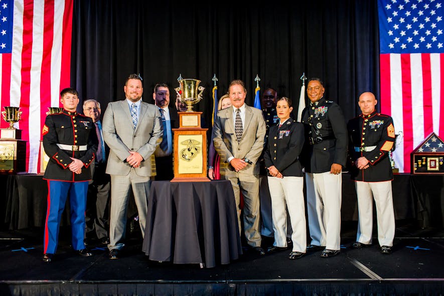 Back Row, Left to Right: Jay Stieber, Gary Walls, Sam Facchini, Dawn Sweeney, Capt. Derrick Oliver. Front Row, Left to Right: Cpl. Brady Wocher, Andrew Bessemer, Barry Lee, W.O. Maria Marques, Major General Craig Crenshaw, and MGySgt Brian Blanton.